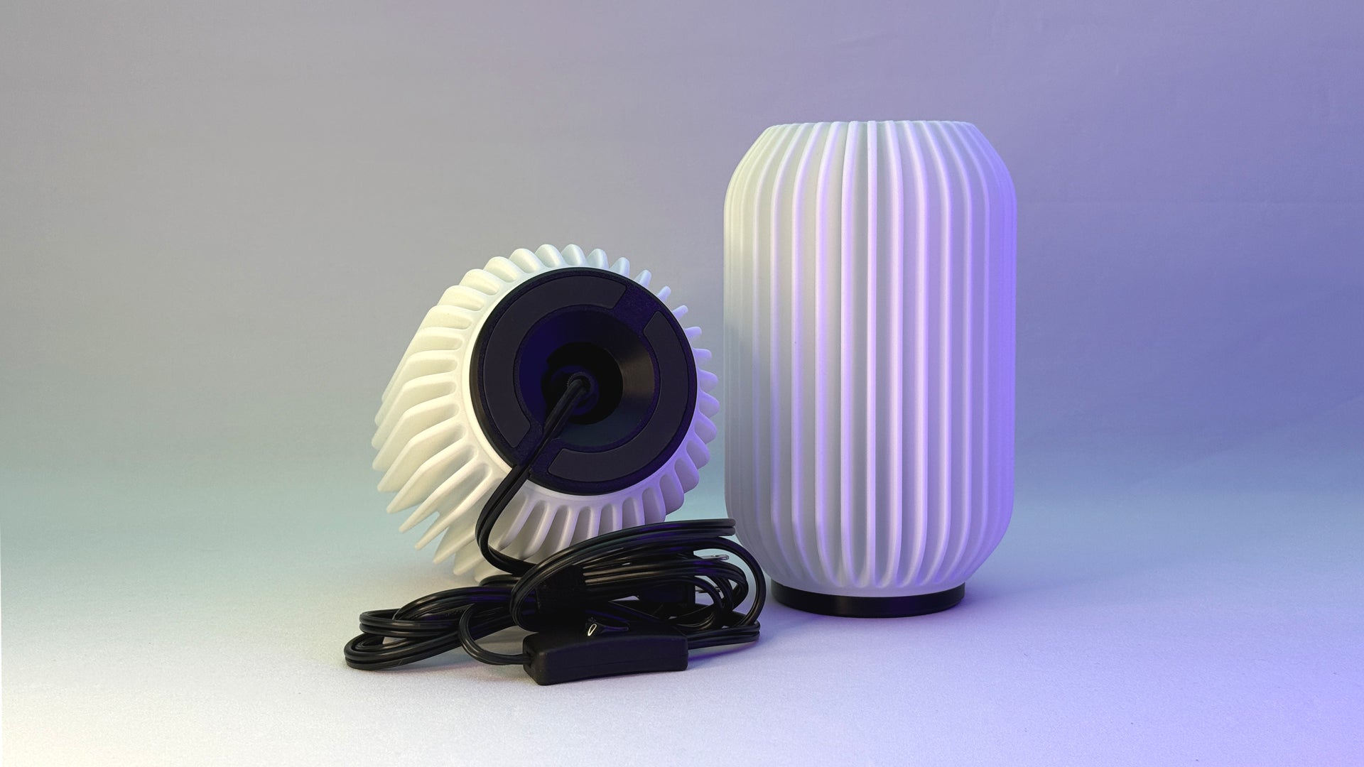 Front and bottom view of Kei 3D printed modern tabletop lamp in Arctic White shade, showing sculpted spiral form and design details