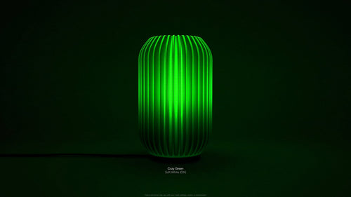 Front view of Kei 3D printed modern tabletop lamp in Cozy Green shade, showing sculpted spiral form with lamp on