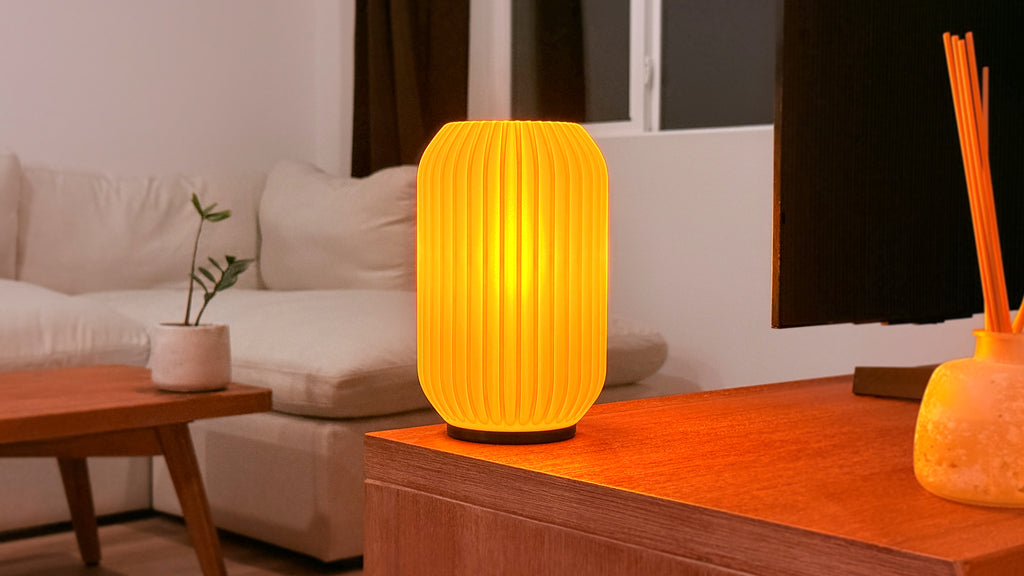 Scenic view of Kei 3D printed modern tabletop lamp in a living room, showing sculpted spiral design and ambient lighting