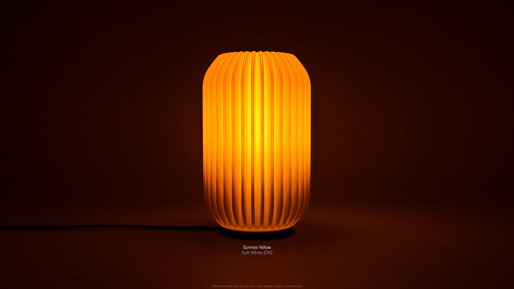 Front view of Kei 3D printed modern tabletop lamp in Sunrise Yellow shade, showing sculpted spiral form with lamp on