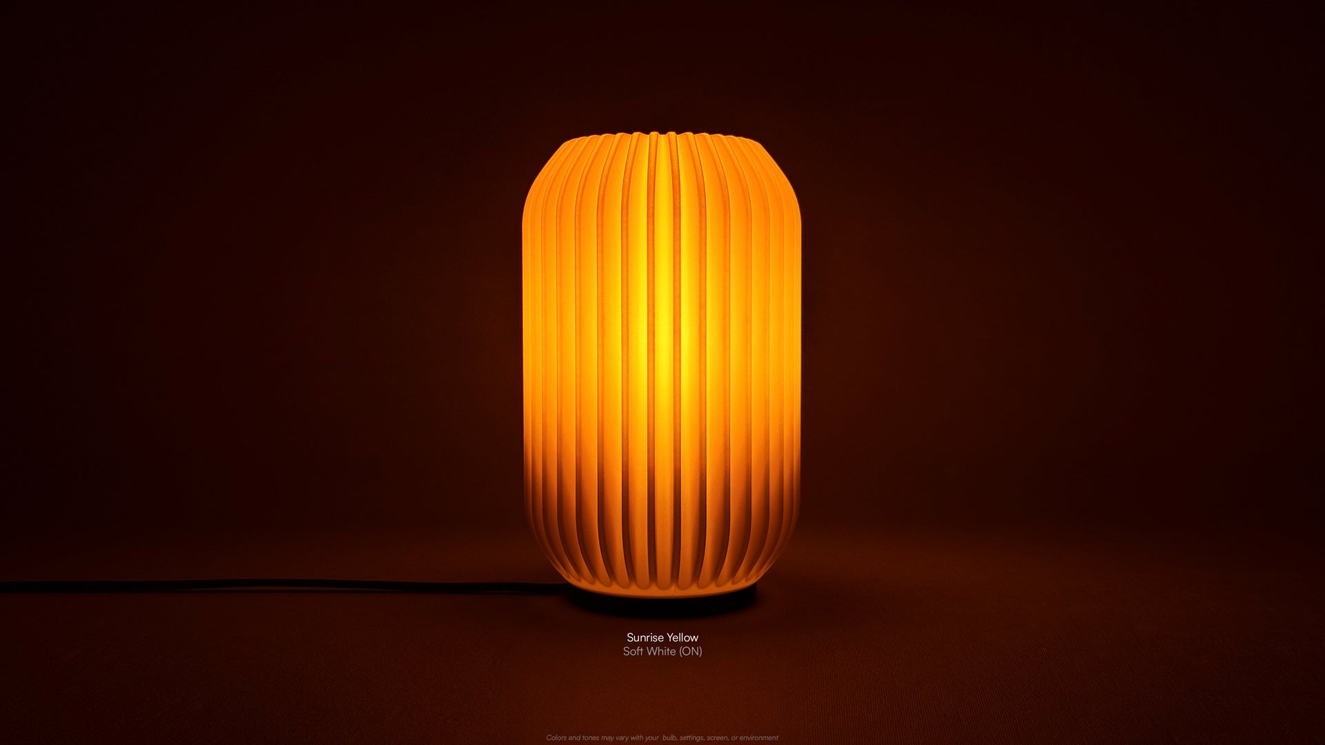 Front view of Kei 3D printed modern tabletop lamp in Sunrise Yellow shade, showing sculpted spiral form with lamp on