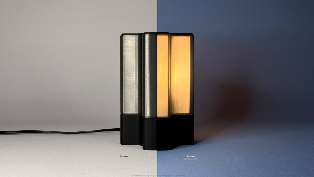 Side view of Nebu 3D printed modern tabletop lamp in smoke shade, showing double-walled transparent design with lamp on and off
