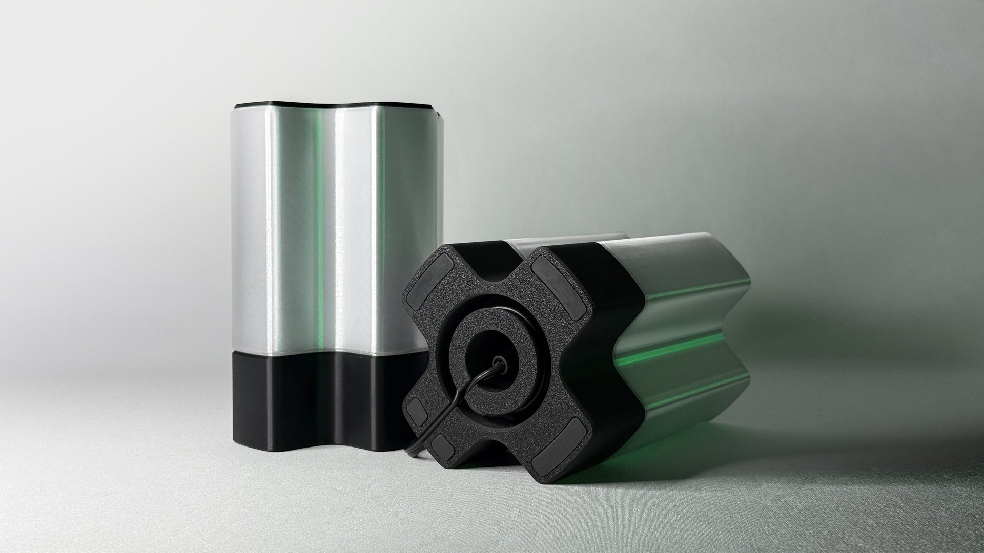 Front and bottom view of Nebu 3D printed modern tabletop lamp in clear shade, showing double-walled transparent design with lamp shown off